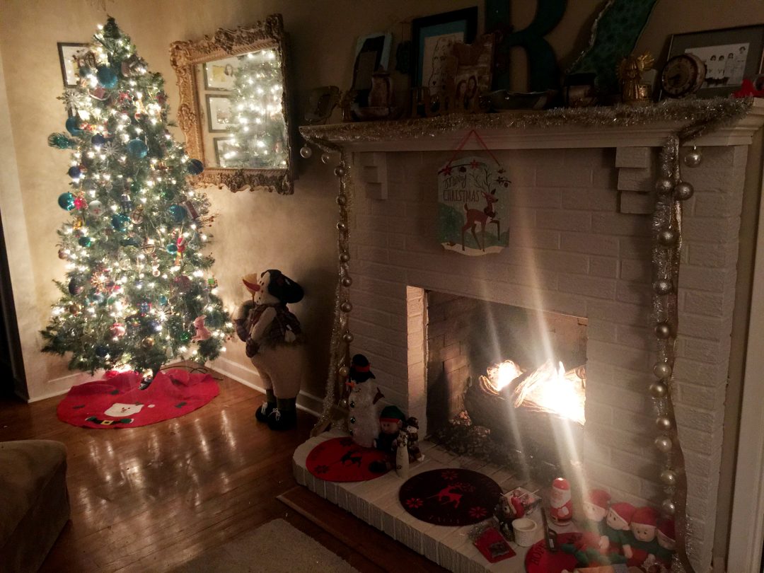 A Christmas-decorated fireplace.
