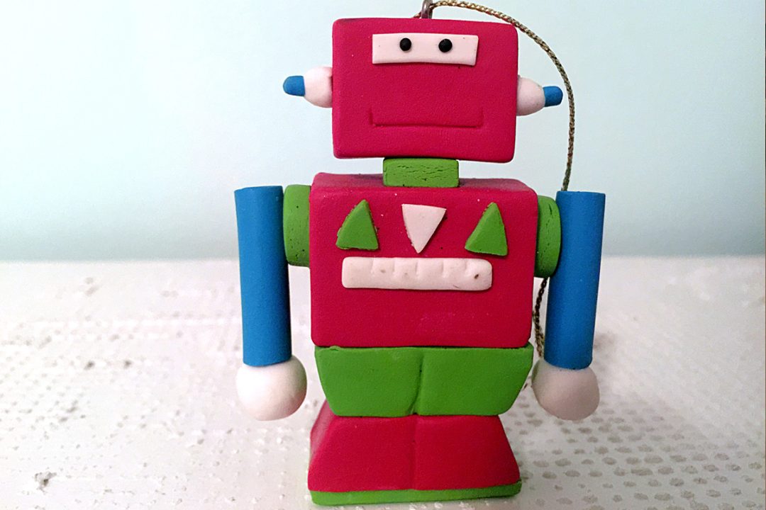 A red robot ornament made of polymer clay.