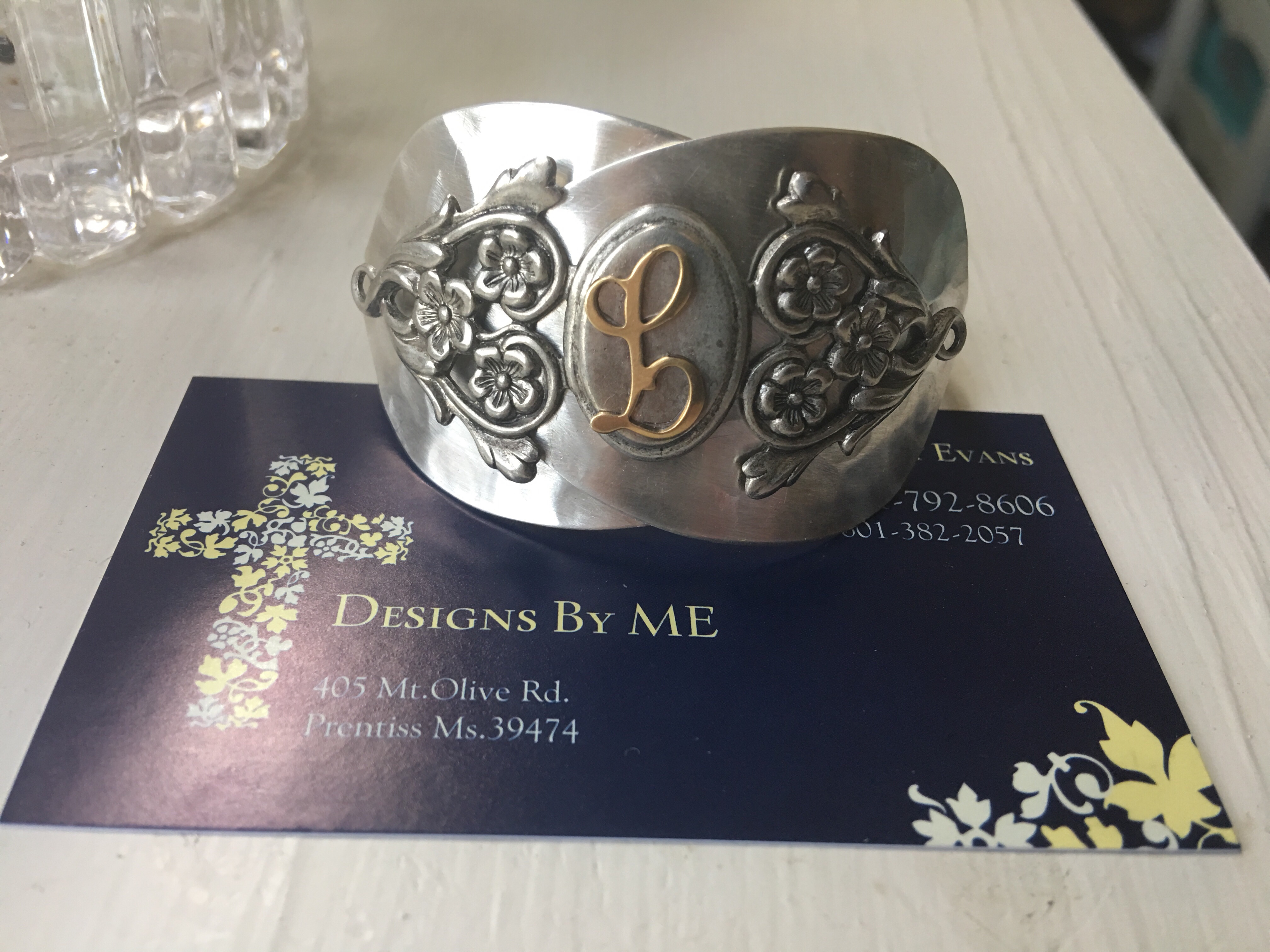 A monogrammed bracelet crafted from silver spoons.