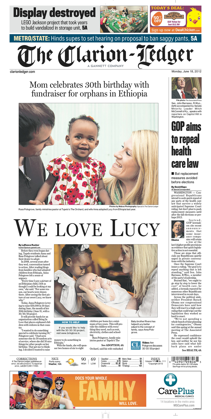A newspaper page featuring a couple who adopted a little girl from Ethiopia.